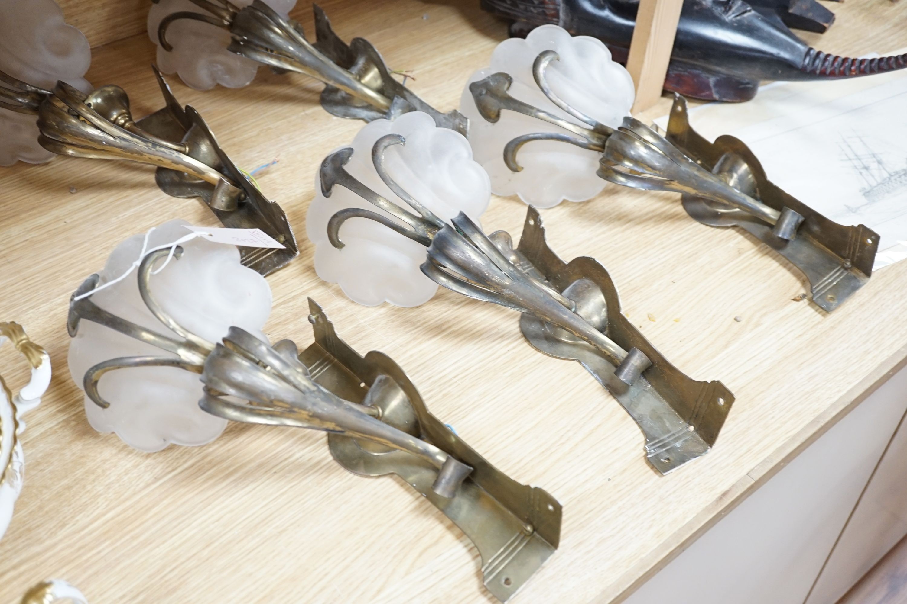 A set of five Art Nouveau style brass corner wall lights with frosted glass shades, 40 cm high